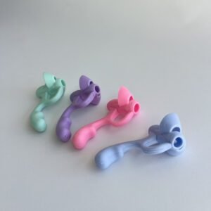 Four pastel-coloured 5-finger pencil grip correctors arranged diagonally on a white surface, showcasing their ergonomic design.