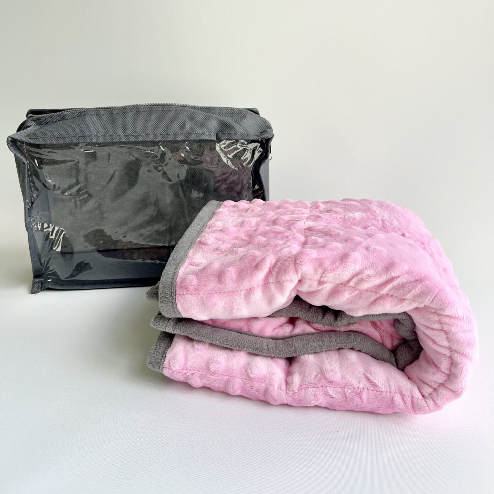 Pink weighted lap pad with grey trim – sensory lap blanket for kids and adults providing calming deep pressure.