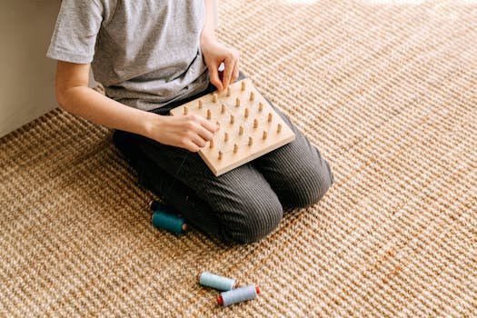 A child focused on threading beads, improving fine motor skills