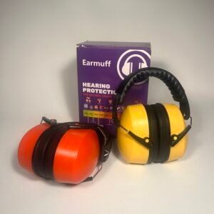 Two pairs of noise cancelling headphones for kids, one orange and one yellow, standing next to a purple Earmuff brand hearing protection box.
