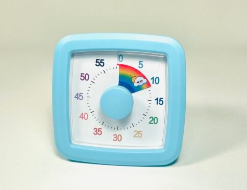 Light blue square visual countdown timer with a white face, black numbers, and a central light blue knob, showing a rainbow segment for 10 minutes.