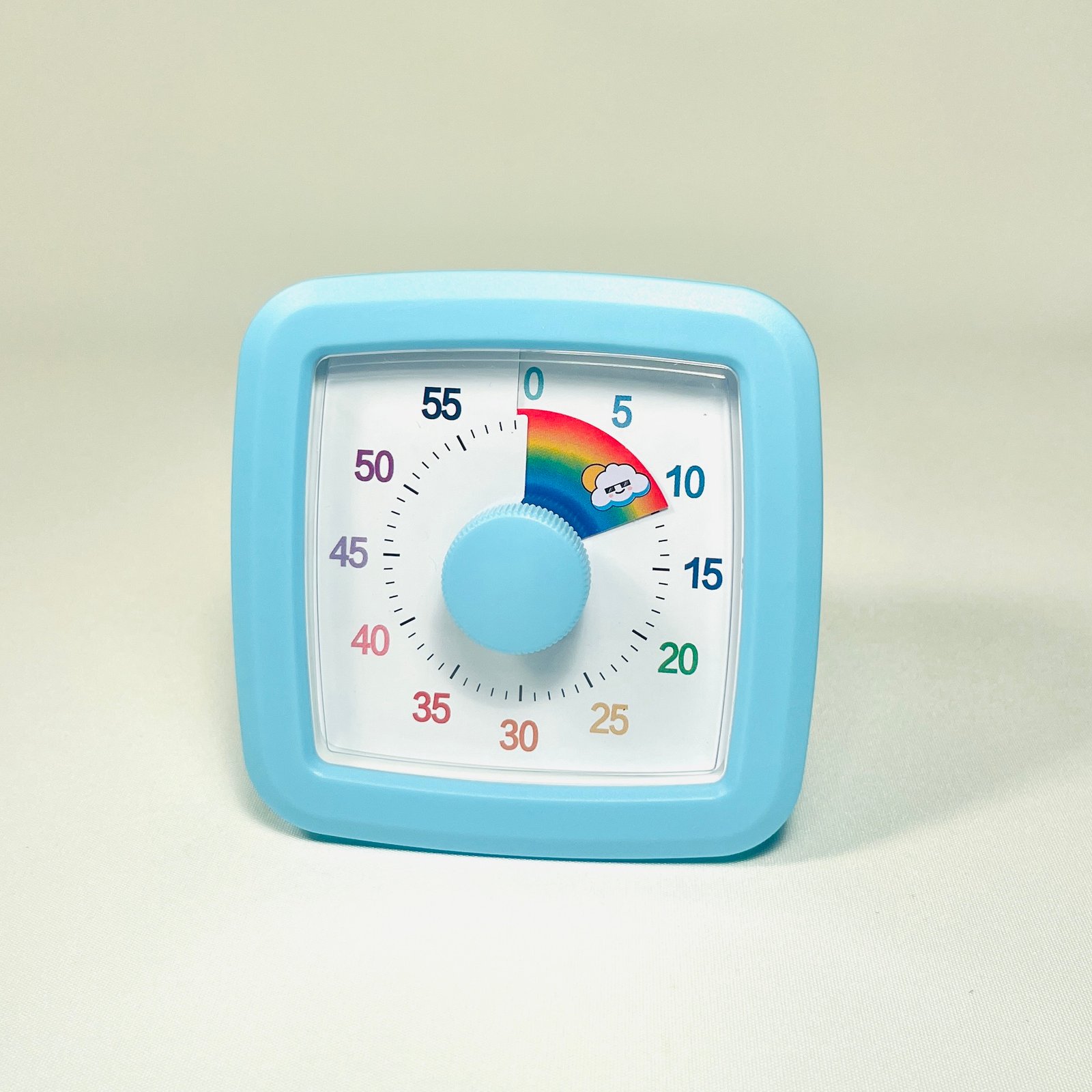 Light blue square visual countdown timer with a white face, black numbers, and a central light blue knob, showing a rainbow segment for 10 minutes.