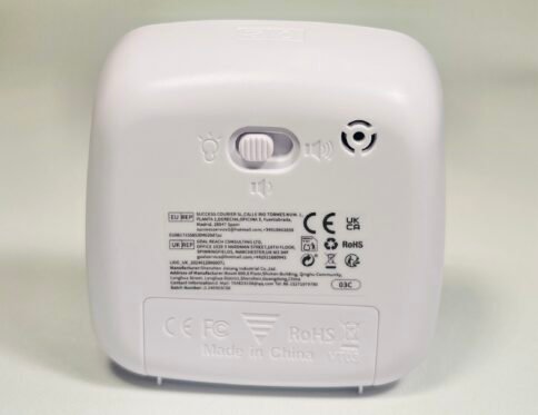 Back of the white visual timer, detailing compliance labels, manufacturer information, and a switch for light and sound settings.