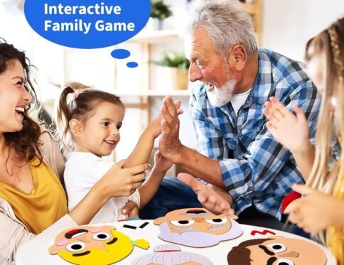 Happy family playing with Emotion Felt Faces. A young girl high-fives her grandfather while her mother smiles, with felt faces laid out on a white table, depicting an interactive family game.