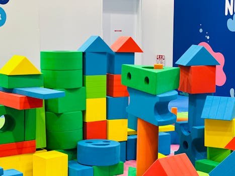 A preschooler intently building a tower with colourful blocks
