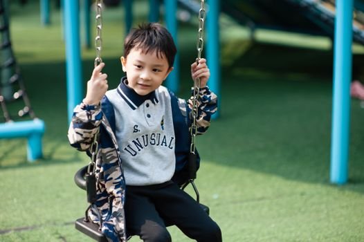 Child enjoying vestibular input on a sensory swing